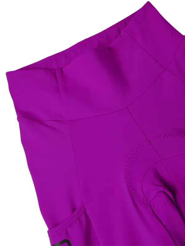 Purple high-waisted cycling shorts with a side cargo pocket a vertical black 'CYCOLGY' logo on the lower left leg, shown against a plain white background.