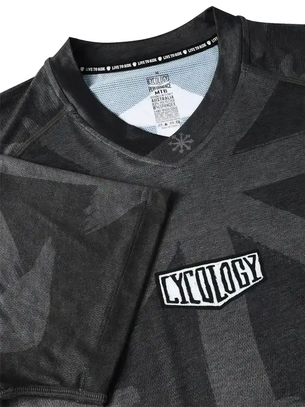 Cycology men's cycling jersey with geometric black camo print and chest logo, performance MTB design