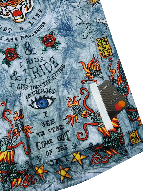 Close-up of a Grey men's cycling jersey with tattoo-style graphics and text 
