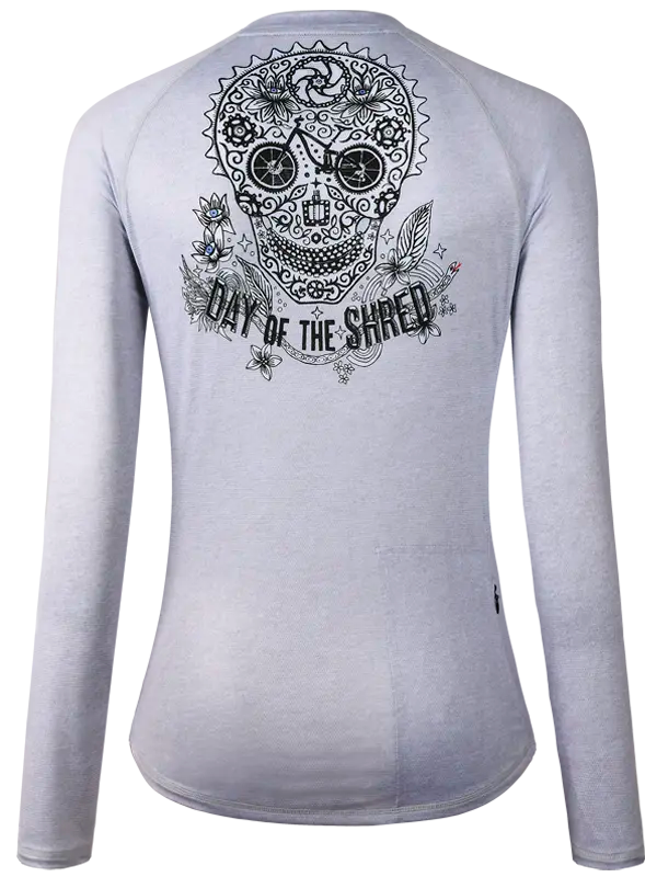 Grey long-sleeve women's  MTB JERSEY with a black skull design and 'Day of the Shred' text on the back.