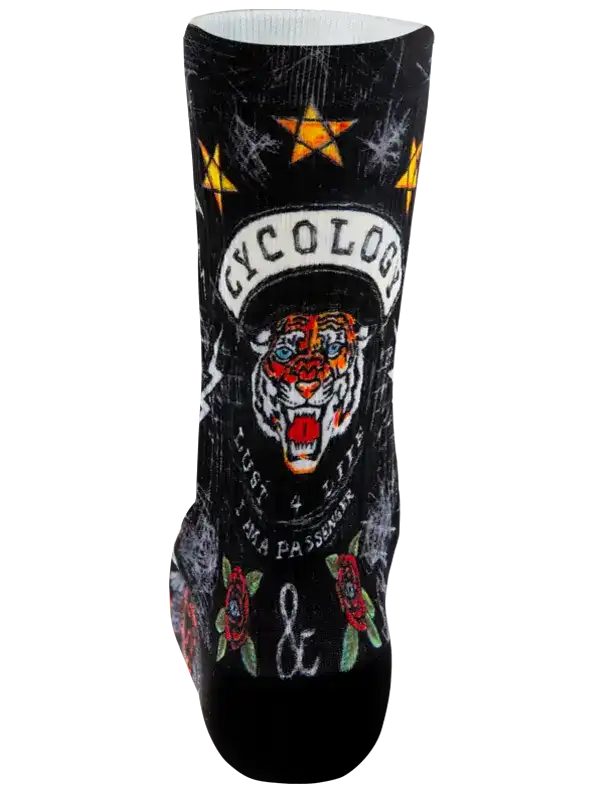 A single crew cycling sock with a black background featuring a graphic design of a tiger with the text 'CYCOLOGY surrounded by yellow stars, roses, and an ampersand.