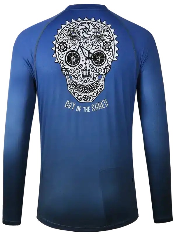 Blue cycling jersey with sugar skull design, 'Day of the Shred' text, long sleeves, rear pocket