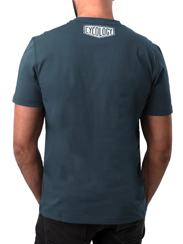 Person wearing a dark blue t-shirt with 'Cycology' logo on the back,