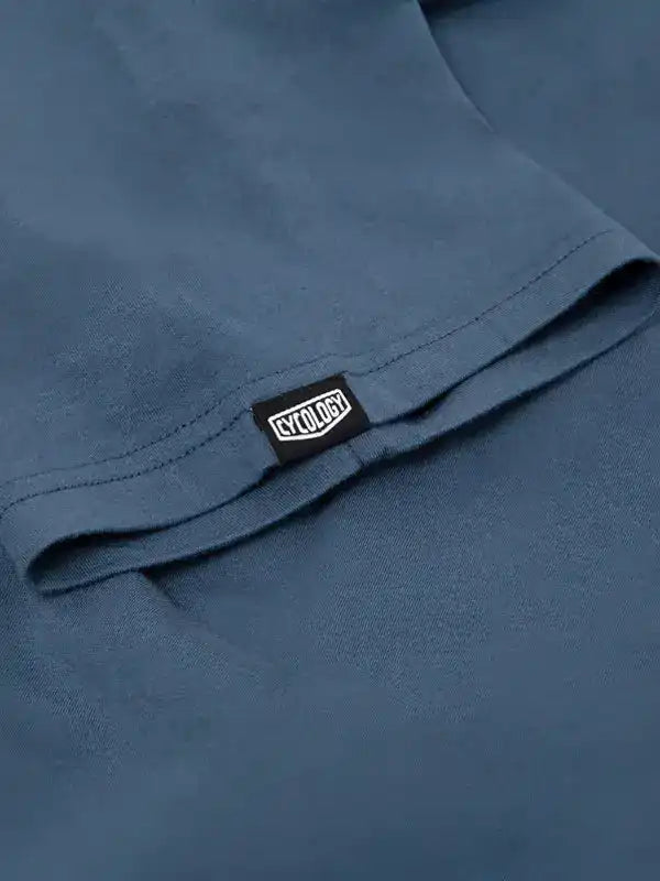 Cycology branded tag on blue cycling apparel, showcasing quality fabric and design detail