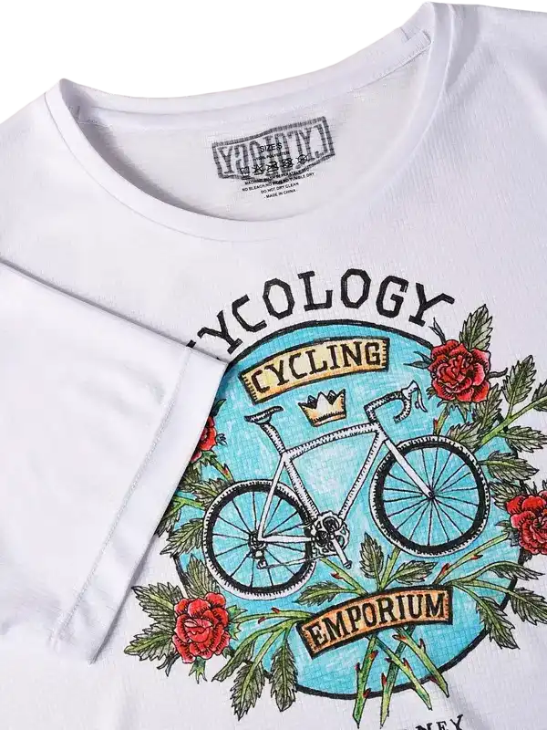 White cycling t-shirt with vintage bike graphic, roses, and 'Cycling Emporium' text