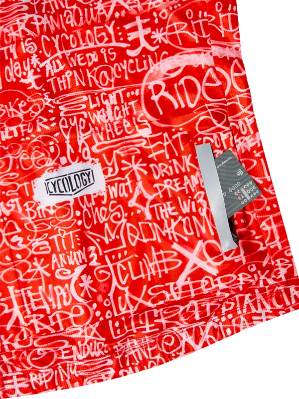 Red cycling jersey with white text pattern and back pockets