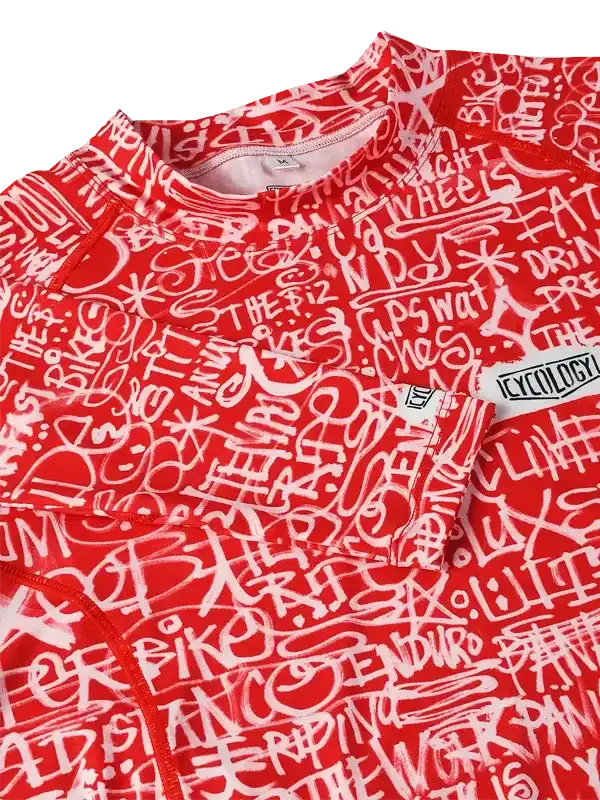 Red cycling jersey with white graffiti-style cycling phrases, featuring 'Cycology' tag
