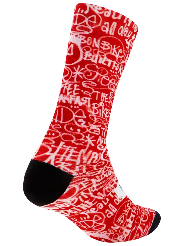 A single crew cycling sock with a red and white graffiti-style pattern featuring the word 'CYCOLOGY' on the side, finished with black toe and heel sections, shown on a plain white background.