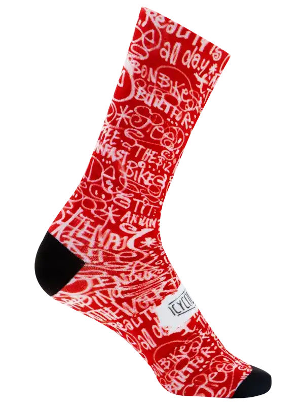 A single crew cycling sock with a red and white graffiti-style pattern featuring the word 'CYCOLOGY' on the side, finished with black toe and heel sections, shown on a plain white background.
