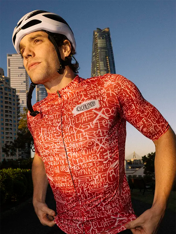 Man wearing red cycling jersey with white text pattern