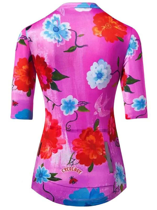 Women's cycling jersey with vibrant floral print in pink, red, and blue, featuring 3/4 sleeves and brand logo.