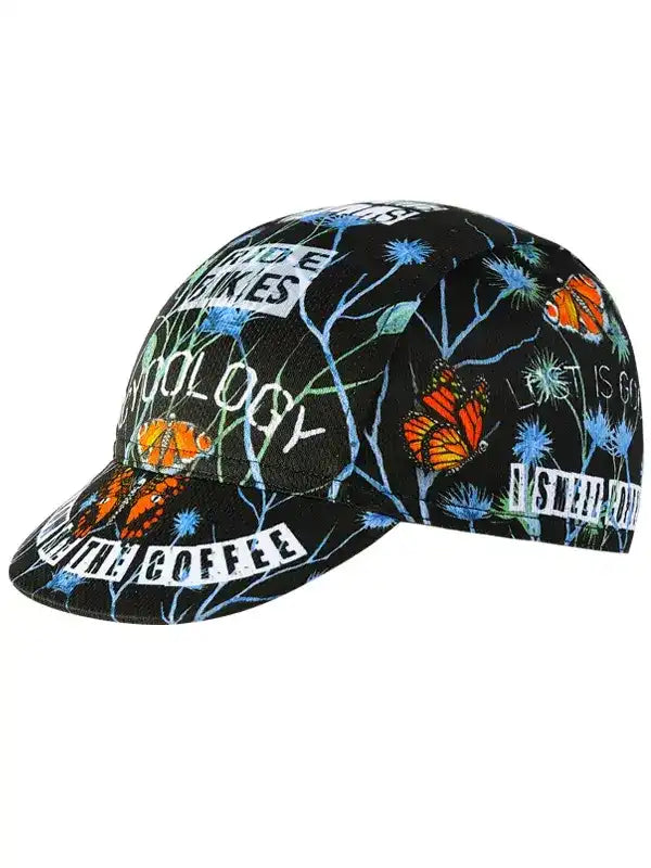 Black cycling cap with butterfly and floral print, featuring 'Ride Makes' and 'Coffee' text for cyclists