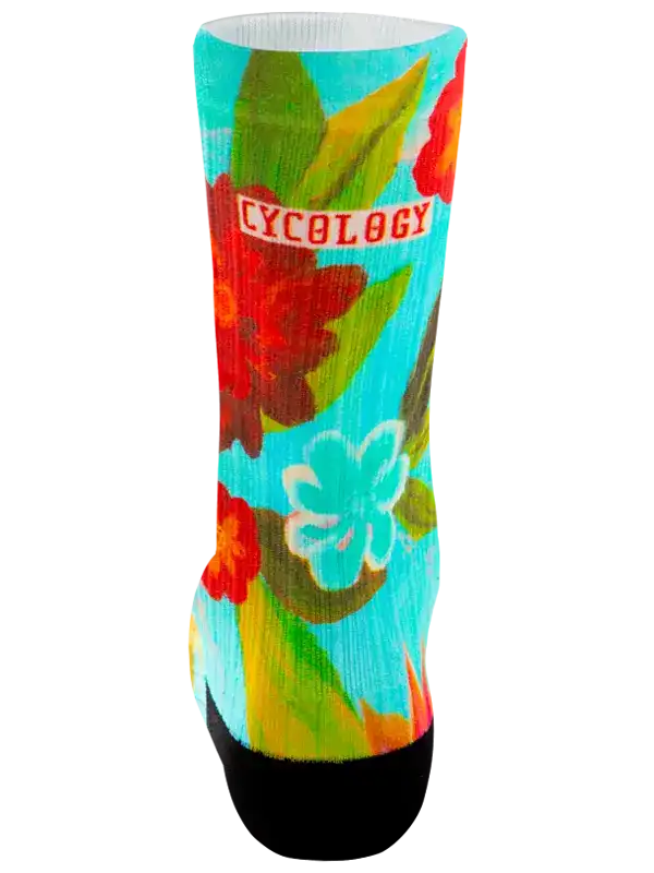 A single crew cycling sock with a colorful tropical floral print on a turquoise background, featuring the word 'CYCOLOGY' in red text across the upper calf, with a black toe and heel.