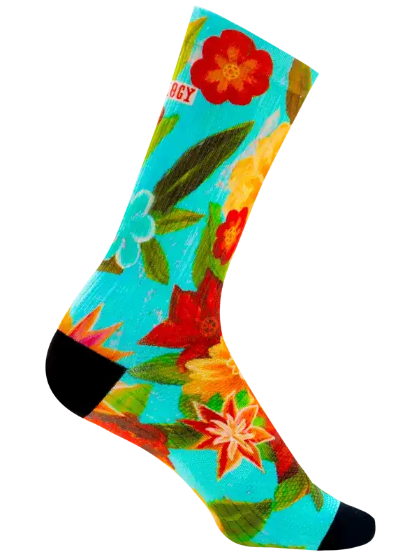 A single crew cycling sock with a vibrant tropical floral print on a turquoise background, featuring red hibiscus and orange flowers, green leaves, and black toe and heel sections.