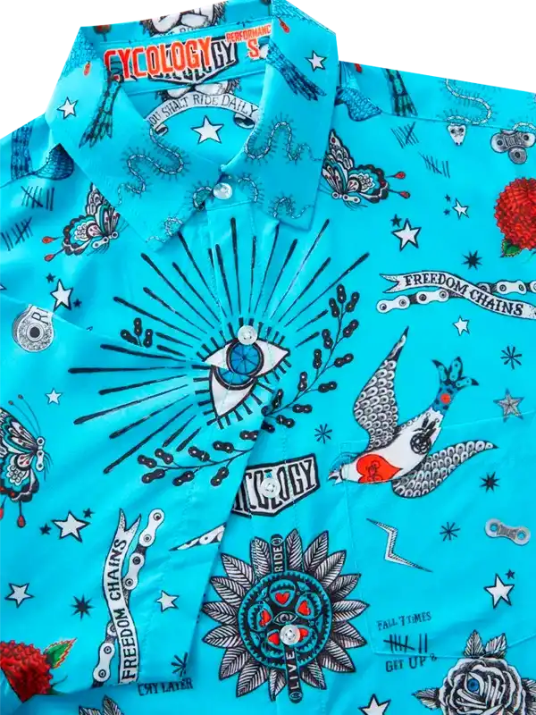 Vibrant turquoise cycling shirt with bold tattoo-style graphics, stars, and freedom chains design