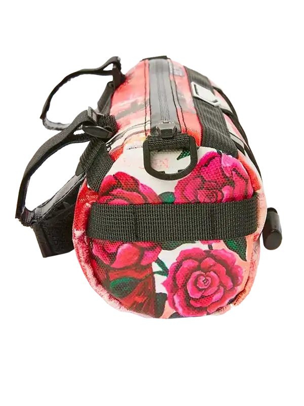 Cycling saddle bag with vibrant rose print, black straps, and zippered closure for bike storage