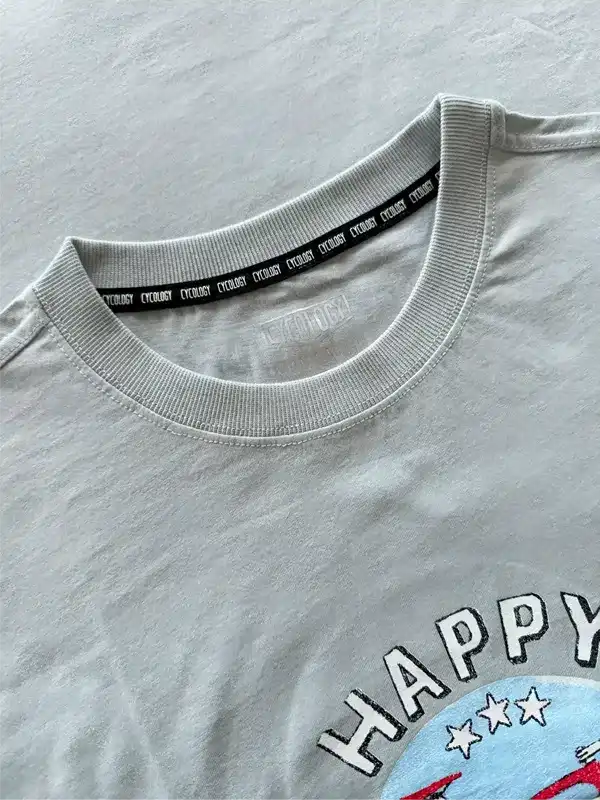 Light grey cycling t-shirt with 'HAPPY' graphic and branded neck tape, soft fabric detail