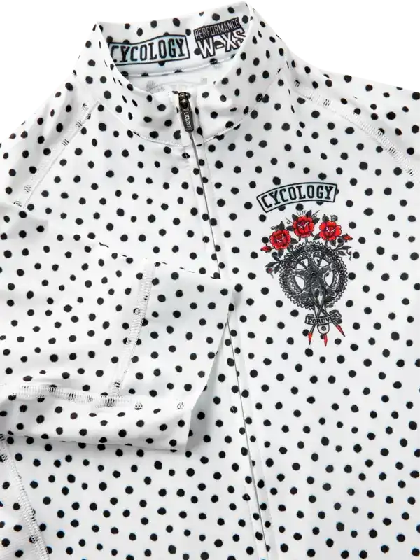 White polka dot women's cycling jersey with red rose graphic and half-zip front