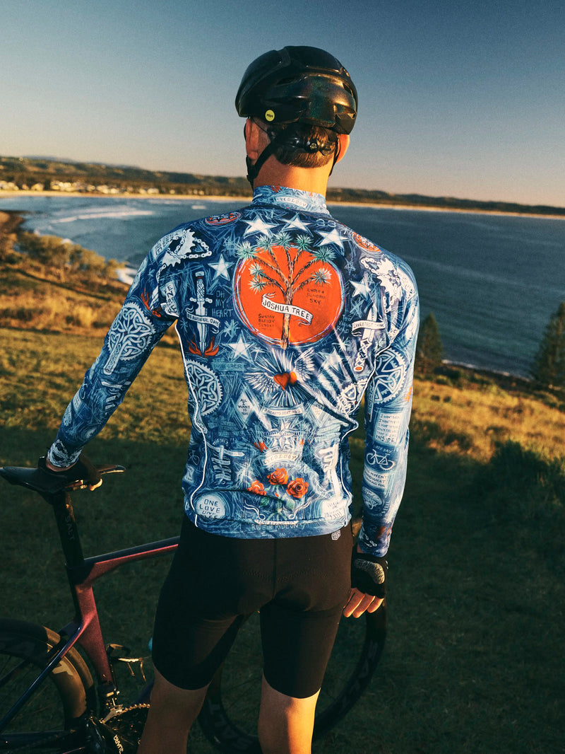 Person wearing a colorful cycling jersey with a scenic background