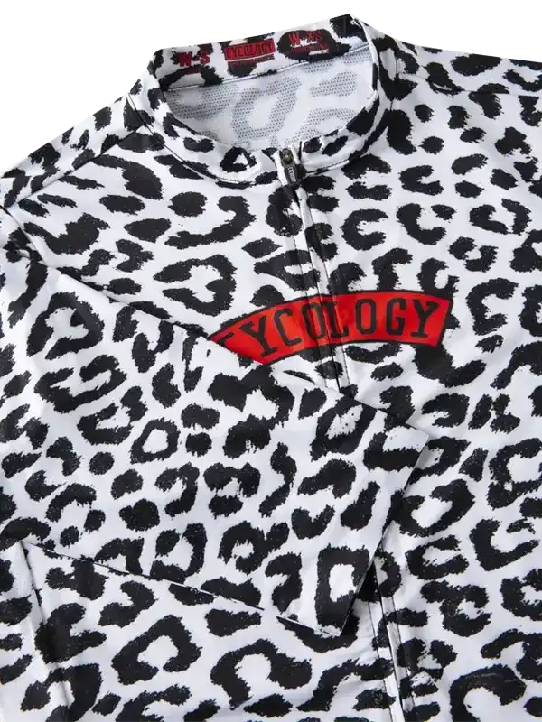 Leopard print cycling jersey with red 'CYCOLOGY' chest logo, featuring half-zip and performance fabric.