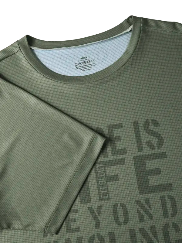 Green athletic shirt with text 