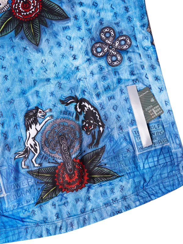 Blue fabric with intricate designs, including animals and text,