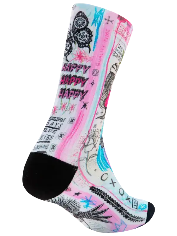 A single crew cycling sock with a vibrant graffiti-style graphic print featuring pink, light blue, black, and white elements, including the words 'HAPPY HAPPY HAPPY' and illustrated doodles, with a solid black heel, toe, and cuff.
