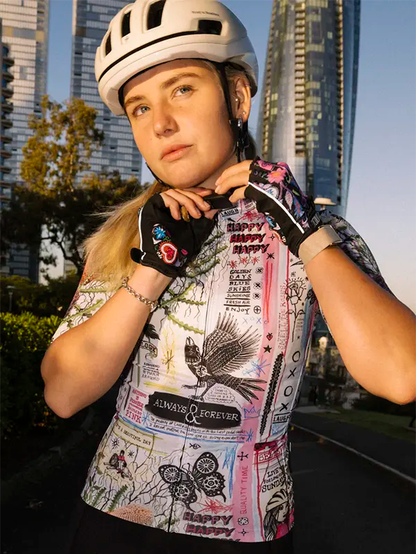 Colorful women's cycling  jersey with nature-themed design and text on a white background