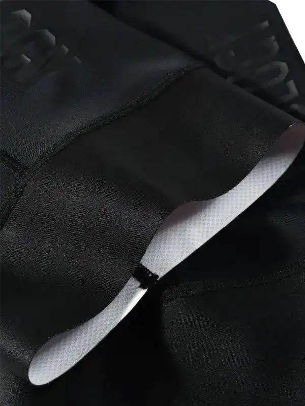 Black cycling shorts with padded chamois and reflective logo detail for men's and women's rides