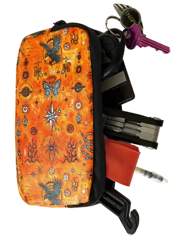 Cycology Clothing Nomad Cycling Wallet with orange pattern, keys, and cycling tools.