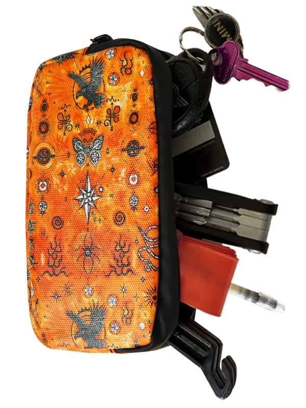 An orange zippered cycling wallet featuring a detailed black, white, and orange spiritual pattern with eagles, a butterfly, a compass rose, and various mystical symbols.