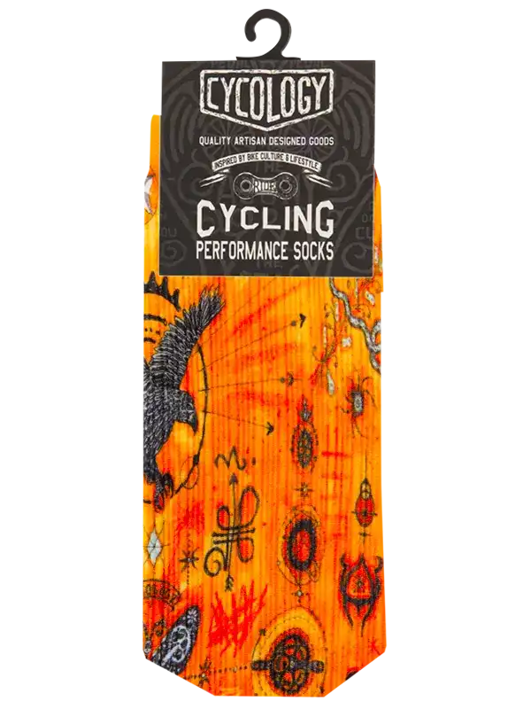 A pair of cycling performance socks in bright orange and yellow with black occult-style symbols, hanging from a black hanger with a black header card that reads 'Cycology Cycling Performance Socks'.