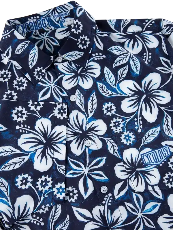 Men's navy cycling shirt with white hibiscus floral print, button-up design, and performance fabric details.