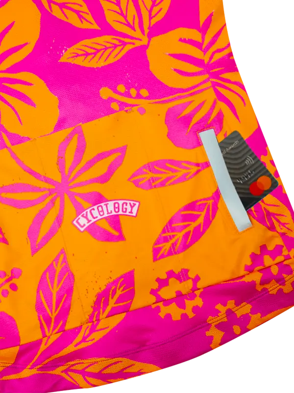 Bright pink and orange patterned fabric with a brand label.