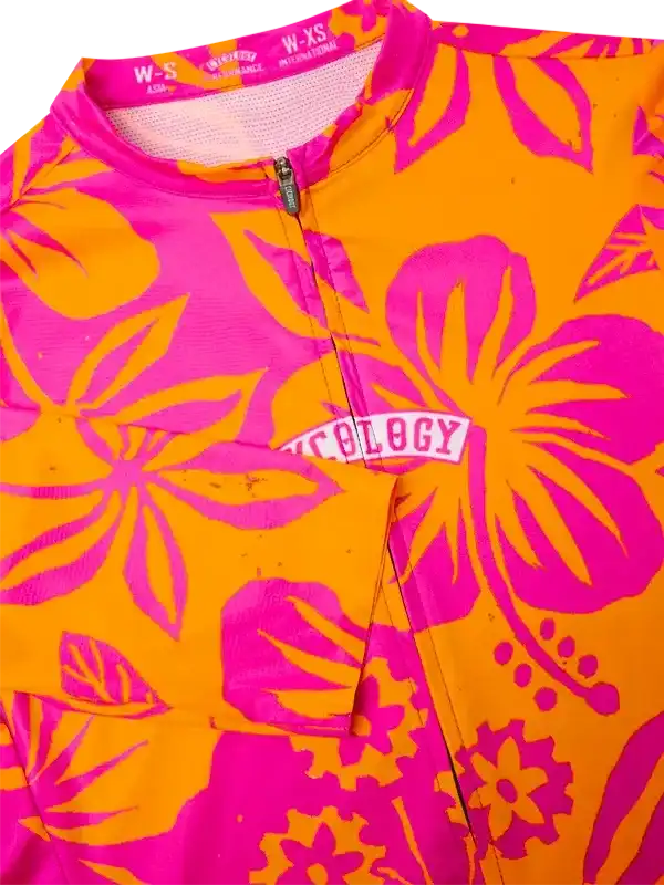 Vibrant orange and pink floral cycling jersey with bold hibiscus print and front zipper
