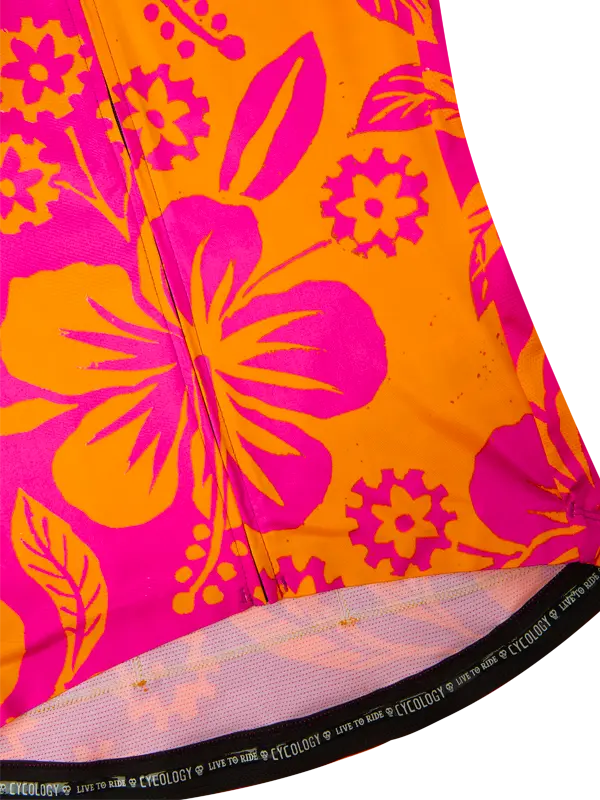 Close-up of a colorful fabric with pink and orange floral patterns on a white background.
