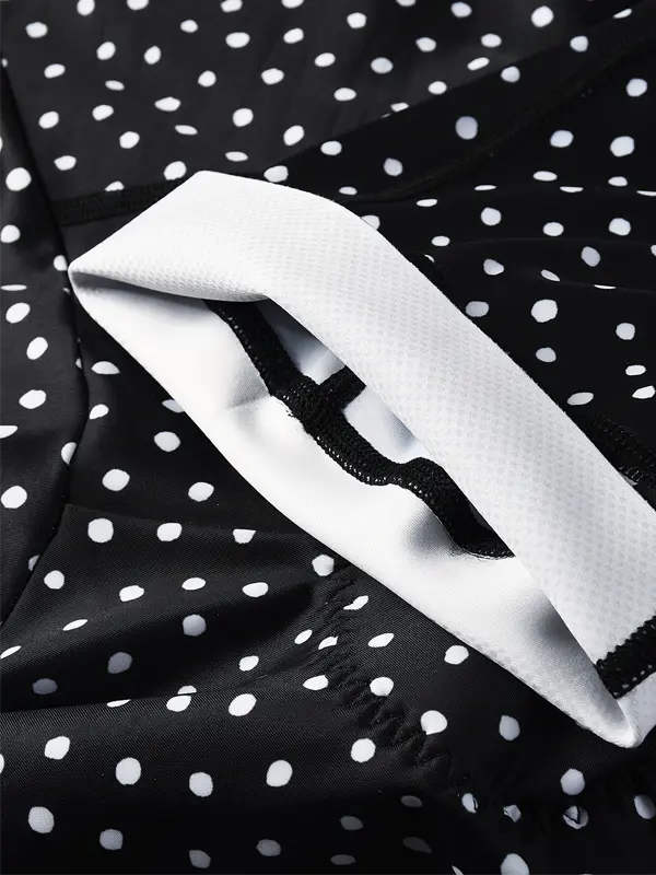 Black cycling bib shorts with white polka dot pattern cuff  grip