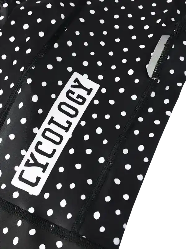 Black and white polka dot cycling jersey with Cycology logo, high-quality fabric design