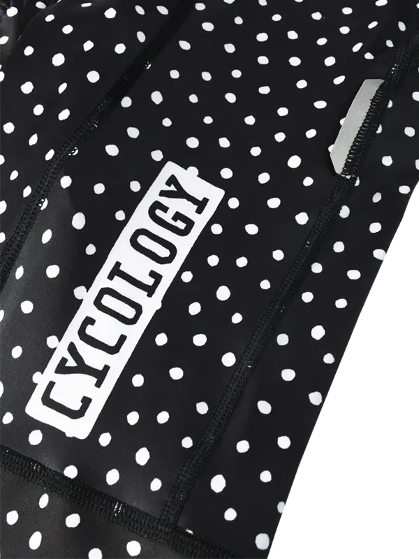 Black cycling bib shorts with white polka dot pattern - leg and CYCOLOGY branding