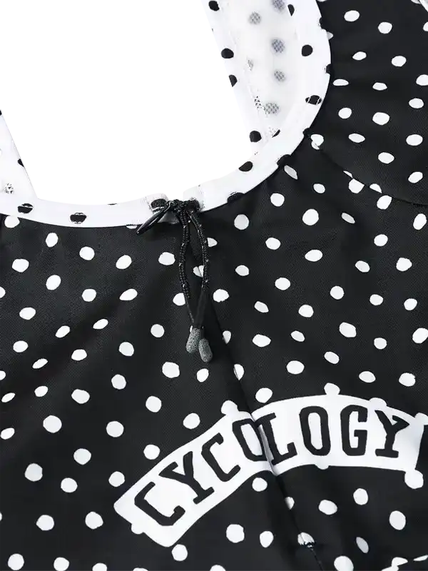 Black and white polka dot cycling jersey with 'CYCOLOGY' logo and drawstring neck