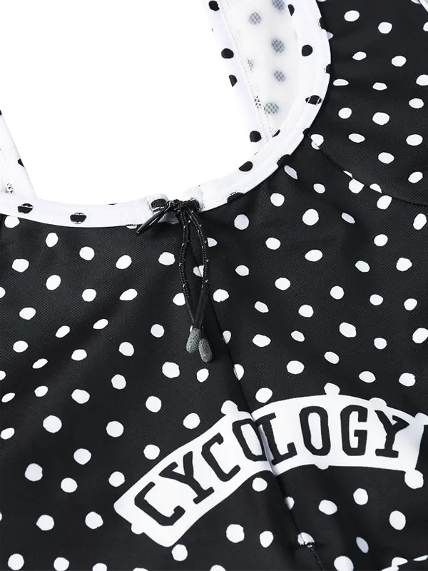 Black cycling bib shorts with white polka dot pattern - braces in white  and quick pee zip at rear.