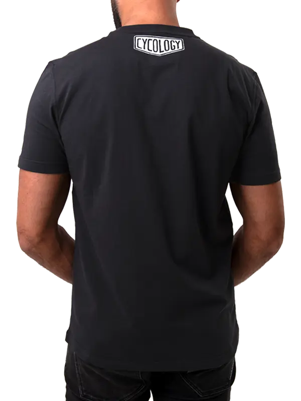 Black t-shirt with 'Cycology' logo on the back worn by a person