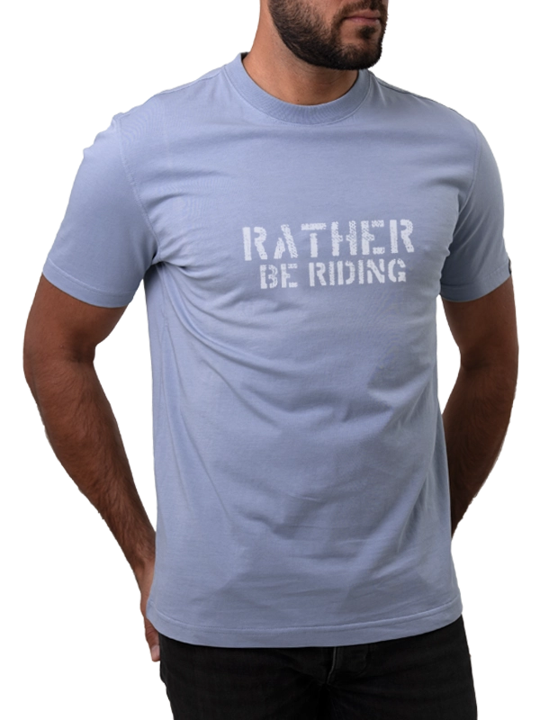 Light blue t-shirt with 'Rather Be Riding' text worn by a person on a white background