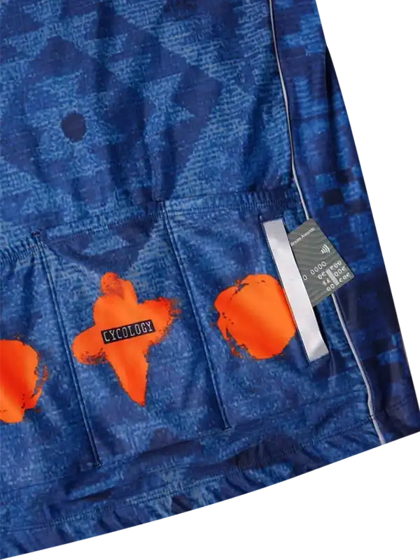 Blue cycling jersey with orange abstract print and rear pockets, featuring Cycology branding