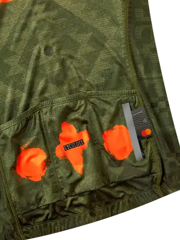Men's cycling jersey with orange graphic print and rear pockets, featuring breathable fabric and secure storage.