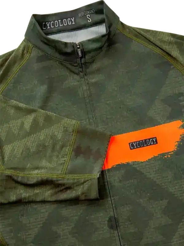 Men's cycling jersey with green camo print, orange accent, and half-zip front