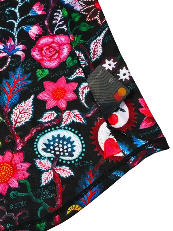 Black cycling jersey with vibrant floral print, pink roses, and motivational phrases like 'RIDE' and 'BLISS'