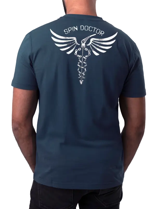 Person wearing a blue t-shirt with 'Spin Doctor' logo on the back