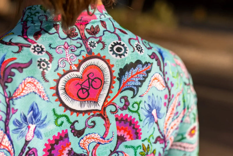 Colorful women's cycling jersey with heart and bike print, floral pattern, breathable fabric