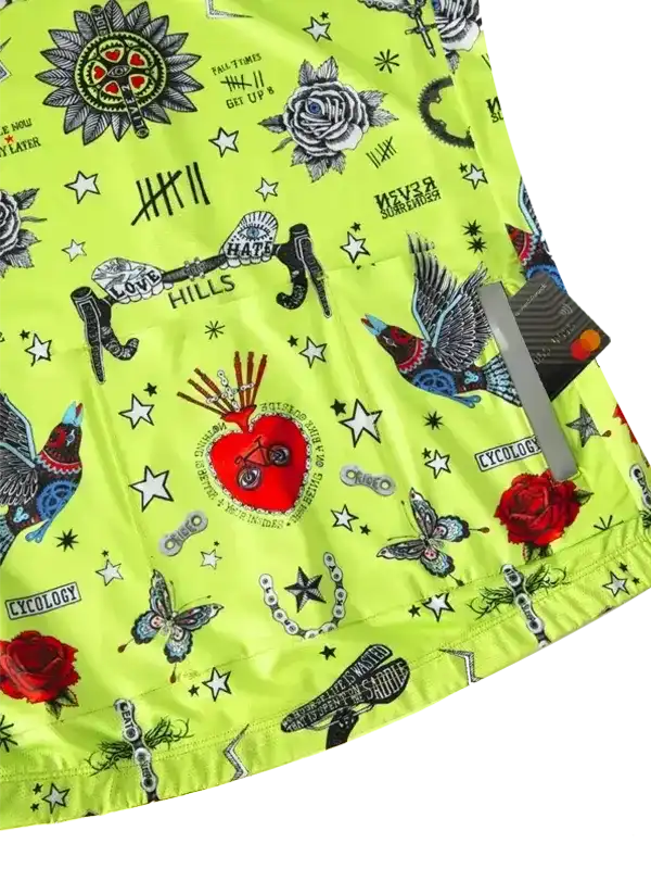 Vibrant neon green cycling jersey with tattoo-style graphics, roses, stars, and bold text designs